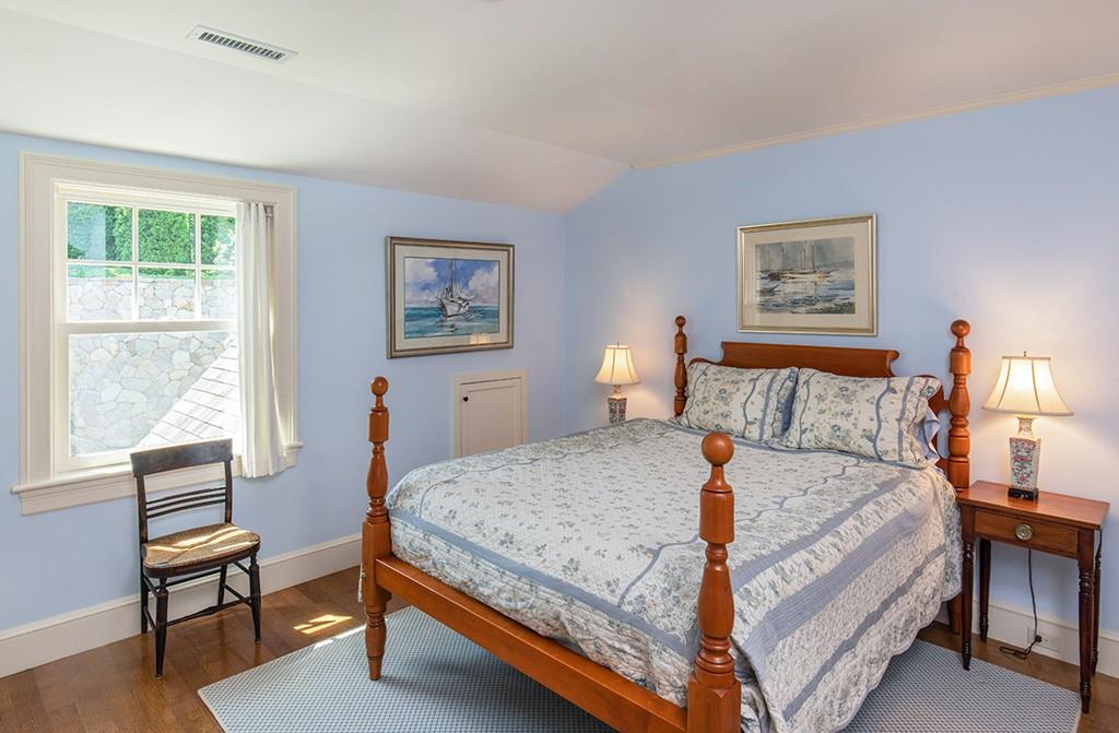 10 Smiths Point Road Manchester, MA 01944 - Photo 19 of 25 a bedroom with a bed a table and chair with a large windows