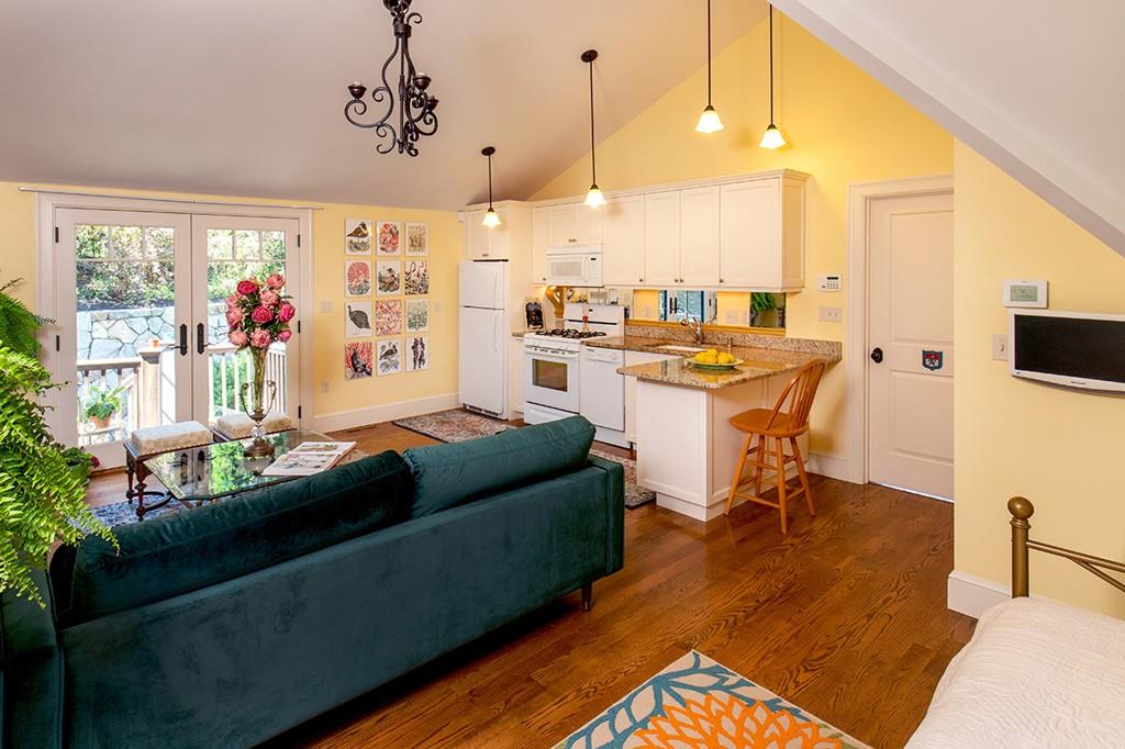 10 Smiths Point Road Manchester, MA 01944 - Photo 21 of 25 a living room with a table chairs and a kitchen view
