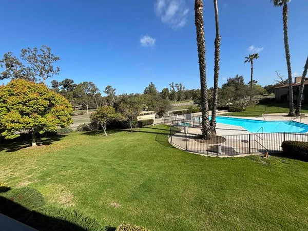 a view of a swimming pool with a yard