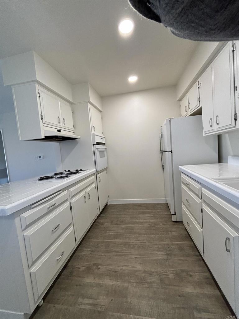 4201 Bonita Road, Unit 242 Bonita, CA 91902 - Photo 5 of 11 a kitchen with cabinets and white appliances