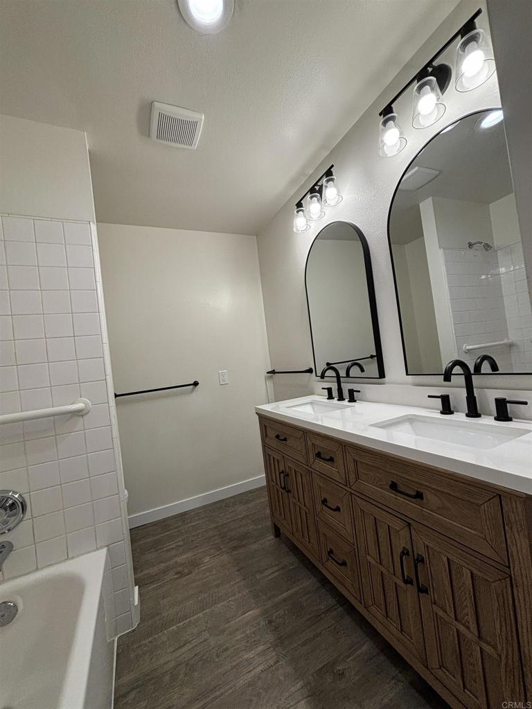 4201 Bonita Road, Unit 242 Bonita, CA 91902 - Photo 6 of 11 a bathroom with a double vanity sink and a mirror