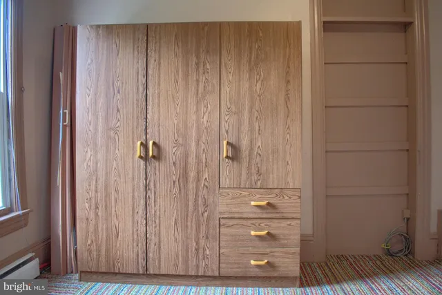 a view of front door with furniture and a window