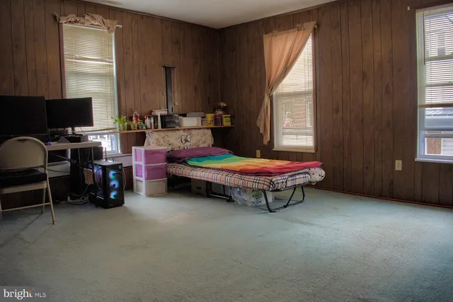 a view of a hallway and a livingroom with a dinning area