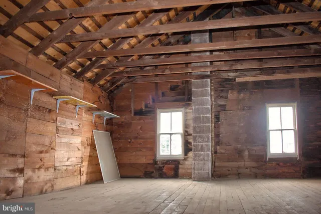 a view of a big room with wooden floors and stairs