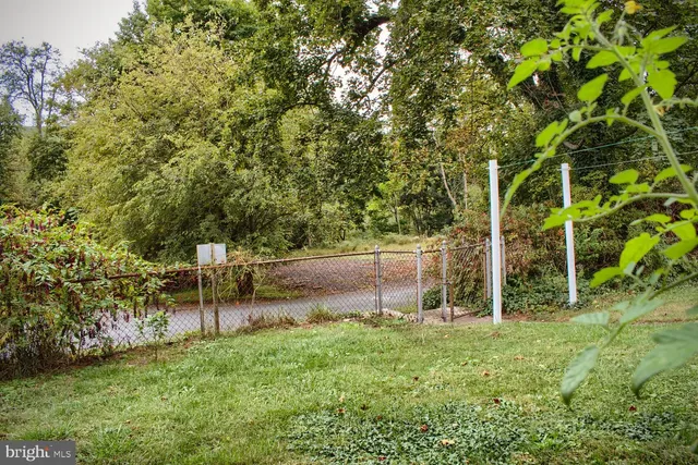 a view of a balcony with wooden floor and fence