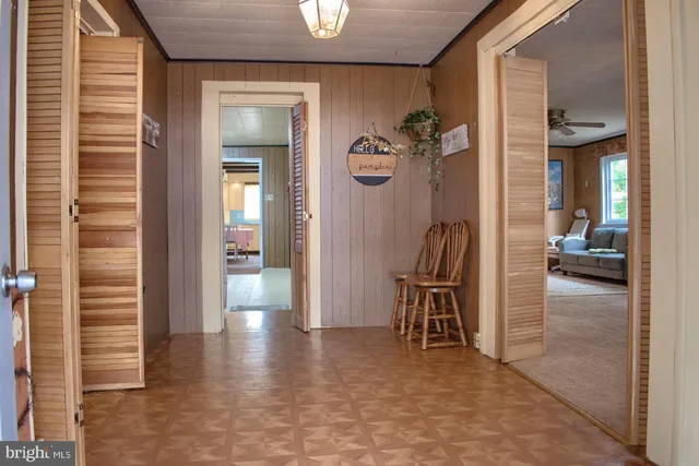 a view of a hallway with furniture and front door