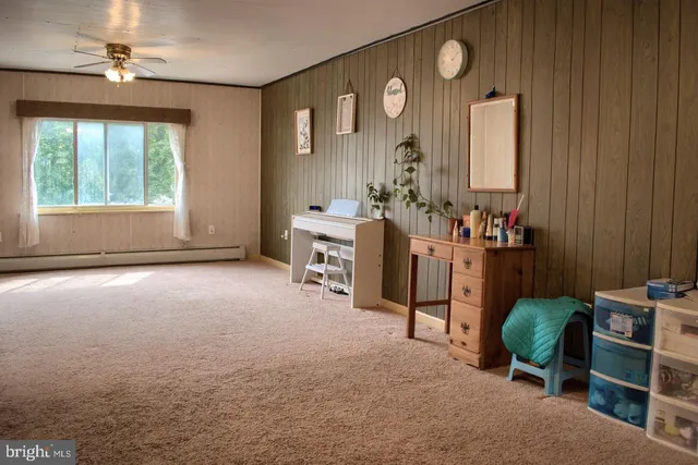 a living room with furniture a window and potted plants