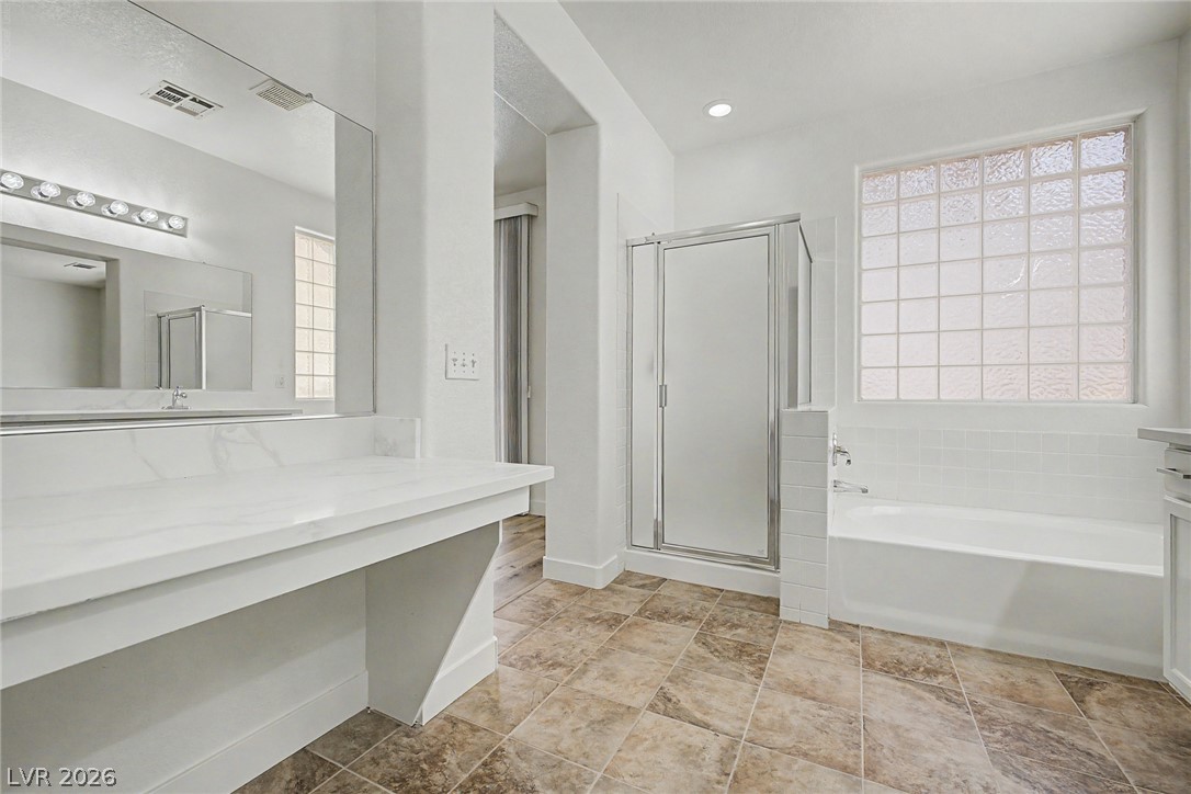 835 Entrada Ridge Avenue Henderson, NV 89012 - Photo 16 of 34 A well-lit bathroom provides a comfortable and convenient space for daily routines.