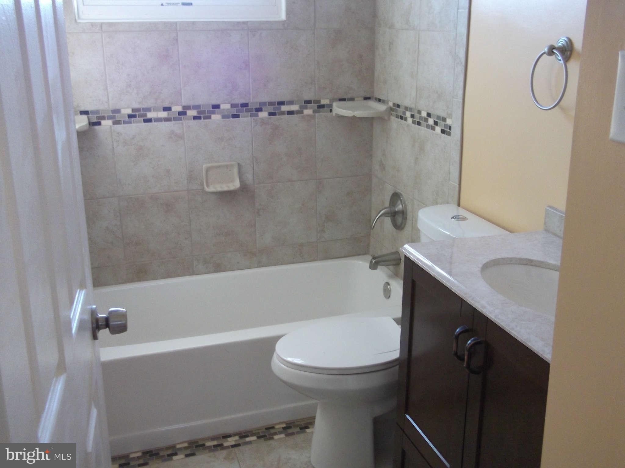 636 Braeside Road Baltimore, MD 21229 - Photo 8 of 30 a bathroom with a granite countertop bathtub shower sink vanity and toilet