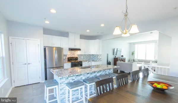 a large kitchen with a table and chairs