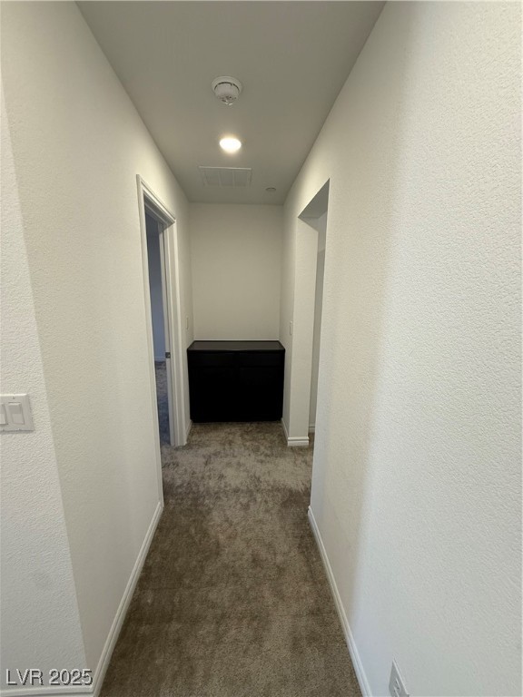 10774 Astell Isle Court Las Vegas, NV 89166 - Photo 14 of 34 Corridor featuring dark carpet and a textured wall