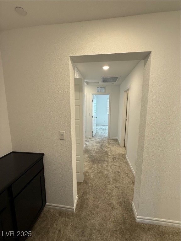 10774 Astell Isle Court Las Vegas, NV 89166 - Photo 23 of 34 Hallway with a textured wall and dark colored carpet