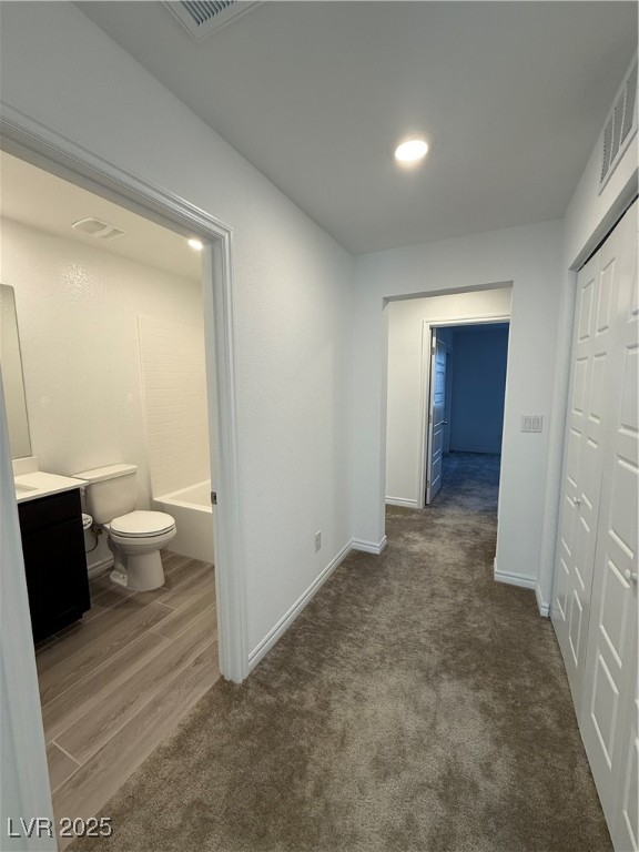 10774 Astell Isle Court Las Vegas, NV 89166 - Photo 25 of 34 Hallway with dark wood finished floors and dark colored carpet