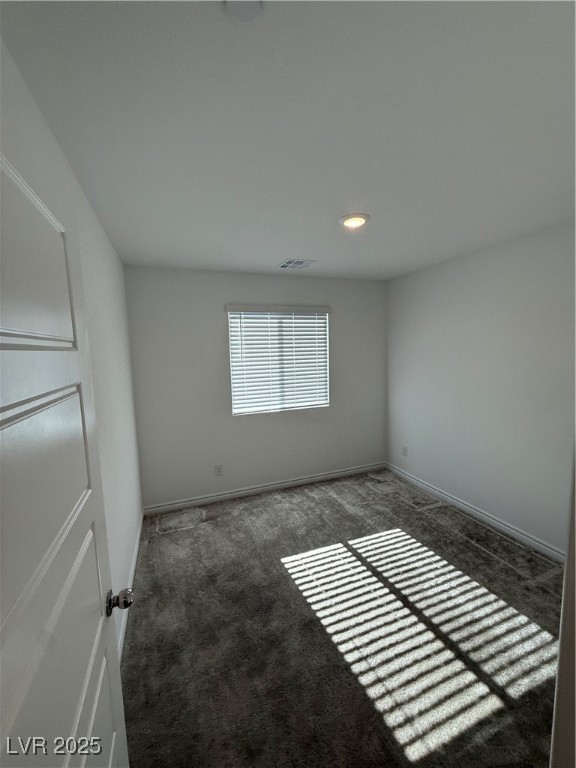 10774 Astell Isle Court Las Vegas, NV 89166 - Photo 26 of 34 Empty room with dark colored carpet and recessed lighting
