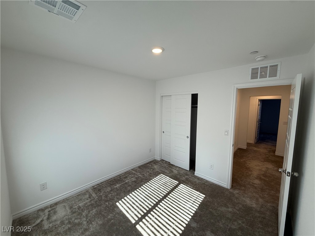 10774 Astell Isle Court Las Vegas, NV 89166 - Photo 28 of 34 Unfurnished bedroom with dark colored carpet, a closet, and recessed lighting