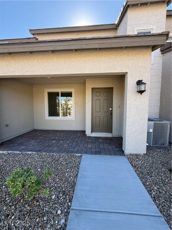 10774 Astell Isle Court Las Vegas, NV 89166 - Photo 3 of 34 Doorway to property with stucco siding