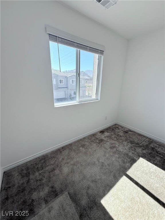 10774 Astell Isle Court Las Vegas, NV 89166 - Photo 31 of 34 Carpeted empty room with baseboards and a mountain view
