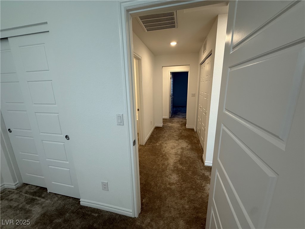 10774 Astell Isle Court Las Vegas, NV 89166 - Photo 32 of 34 Hall with dark carpet and baseboards