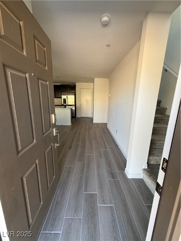 10774 Astell Isle Court Las Vegas, NV 89166 - Photo 4 of 34 Hallway with wood finish floors and stairs