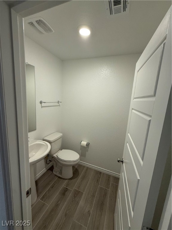 10774 Astell Isle Court Las Vegas, NV 89166 - Photo 10 of 34 Bathroom featuring wood tiled floors and toilet