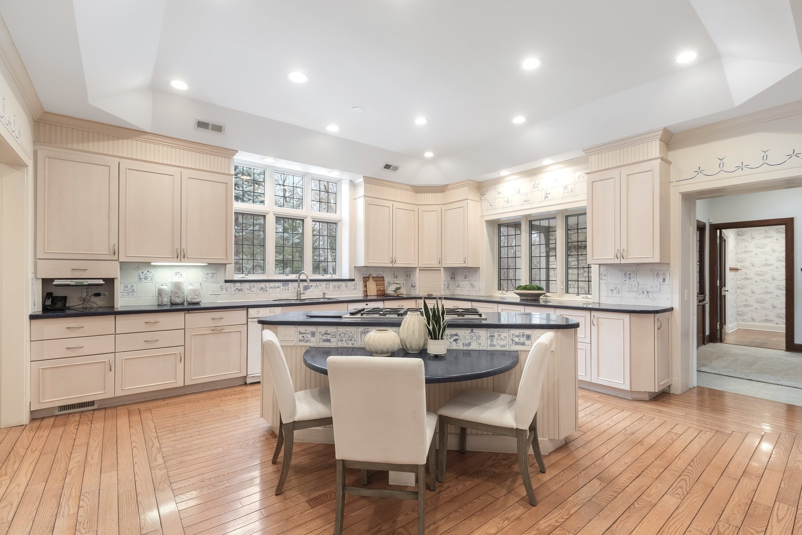 1650 Green Bay Road Lake Bluff, IL 60044 - Photo 25 of 63 a kitchen with a dining table chairs wooden floor cabinets and appliances