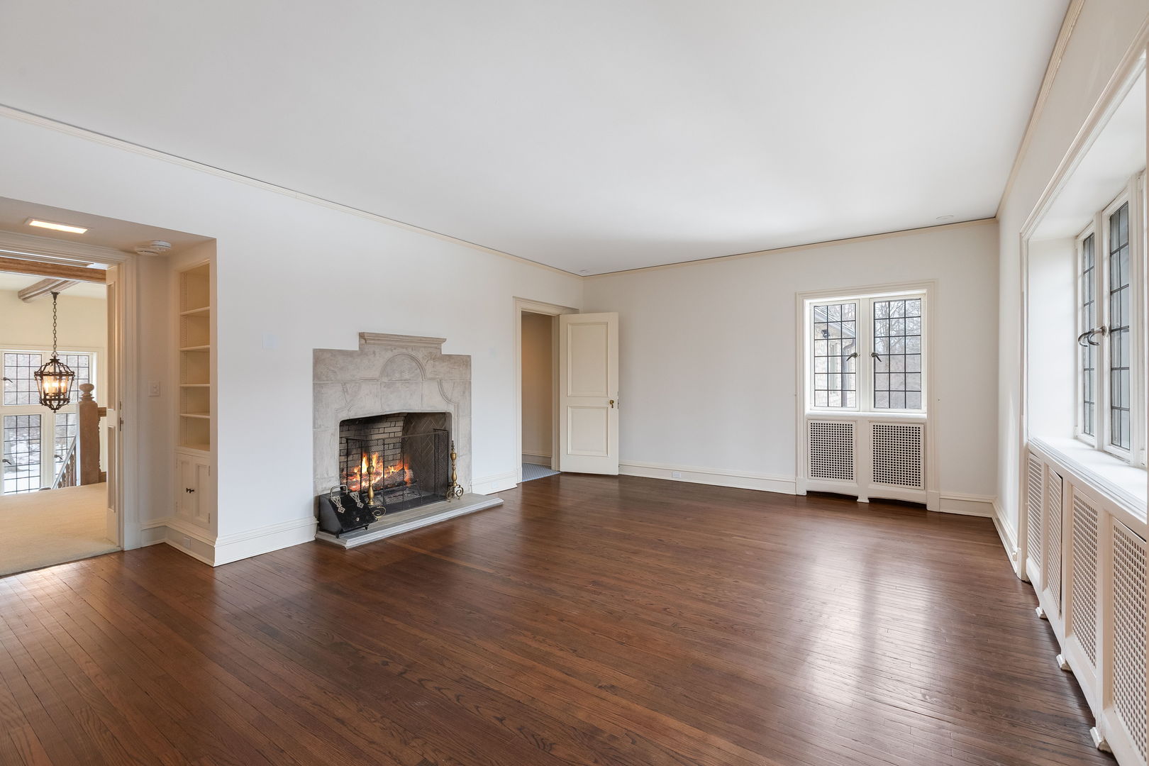 1650 Green Bay Road Lake Bluff, IL 60044 - Photo 40 of 63 an empty room with wooden floor fireplace and windows