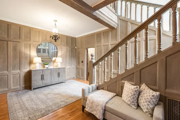 a living room with furniture and a chandelier