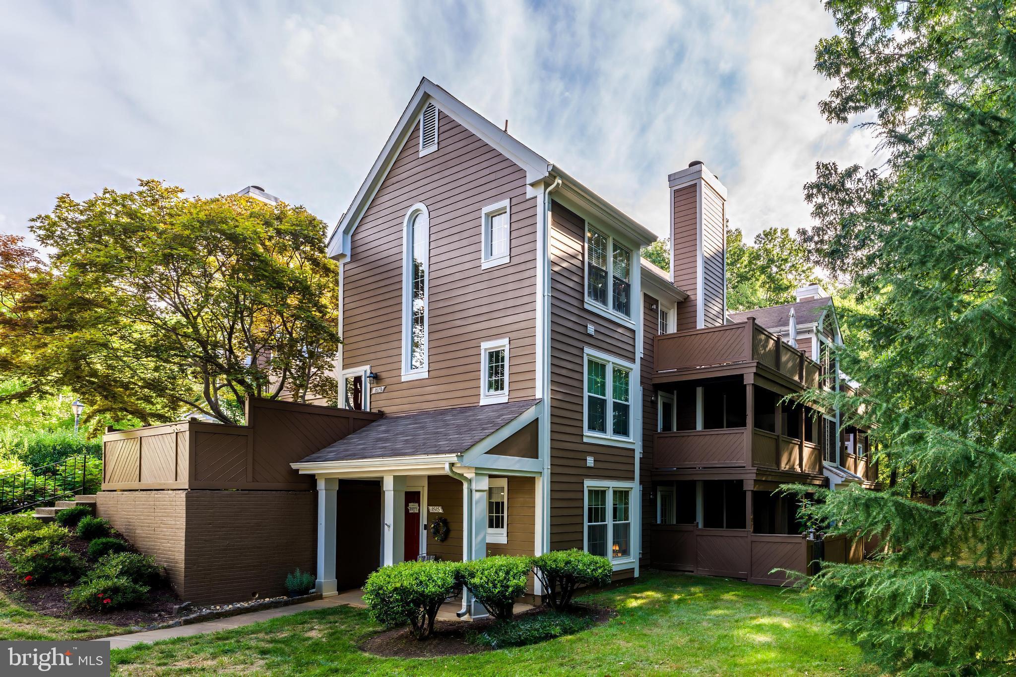 1519 Church Hill Place Reston, VA 20194 - Photo 7 of 14 a view of a brick house with a yard plants and large tree