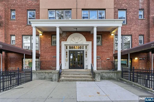 a view of a brick building with many windows