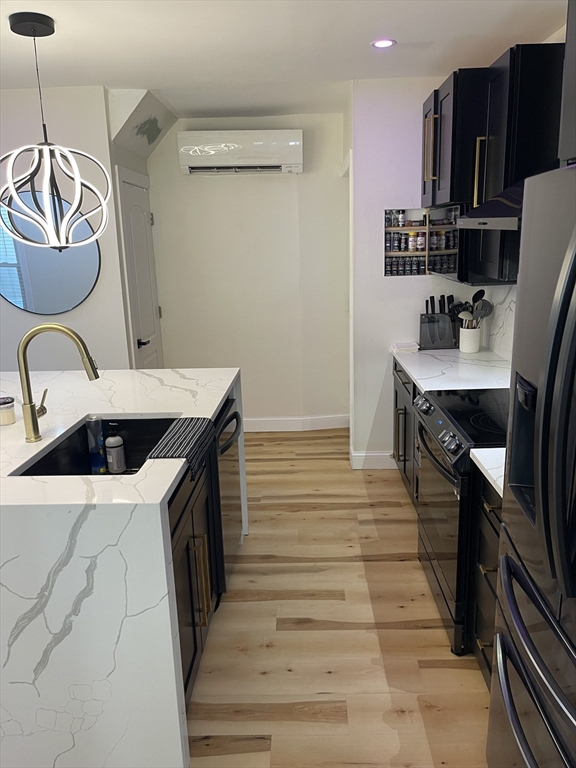 35 Riverview Drive Gill, MA 01354 - Photo 22 of 25 a kitchen with a stove a refrigerator and wooden floor