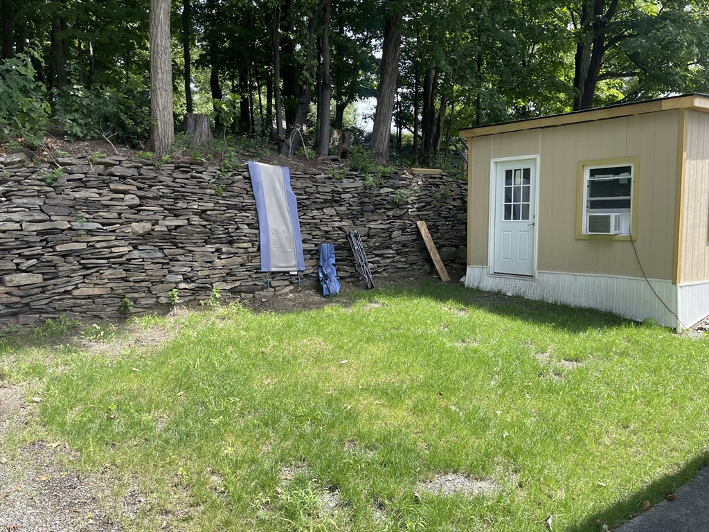 35 Riverview Drive Gill, MA 01354 - Photo 3 of 25 a view of a backyard with potted plants and large tree