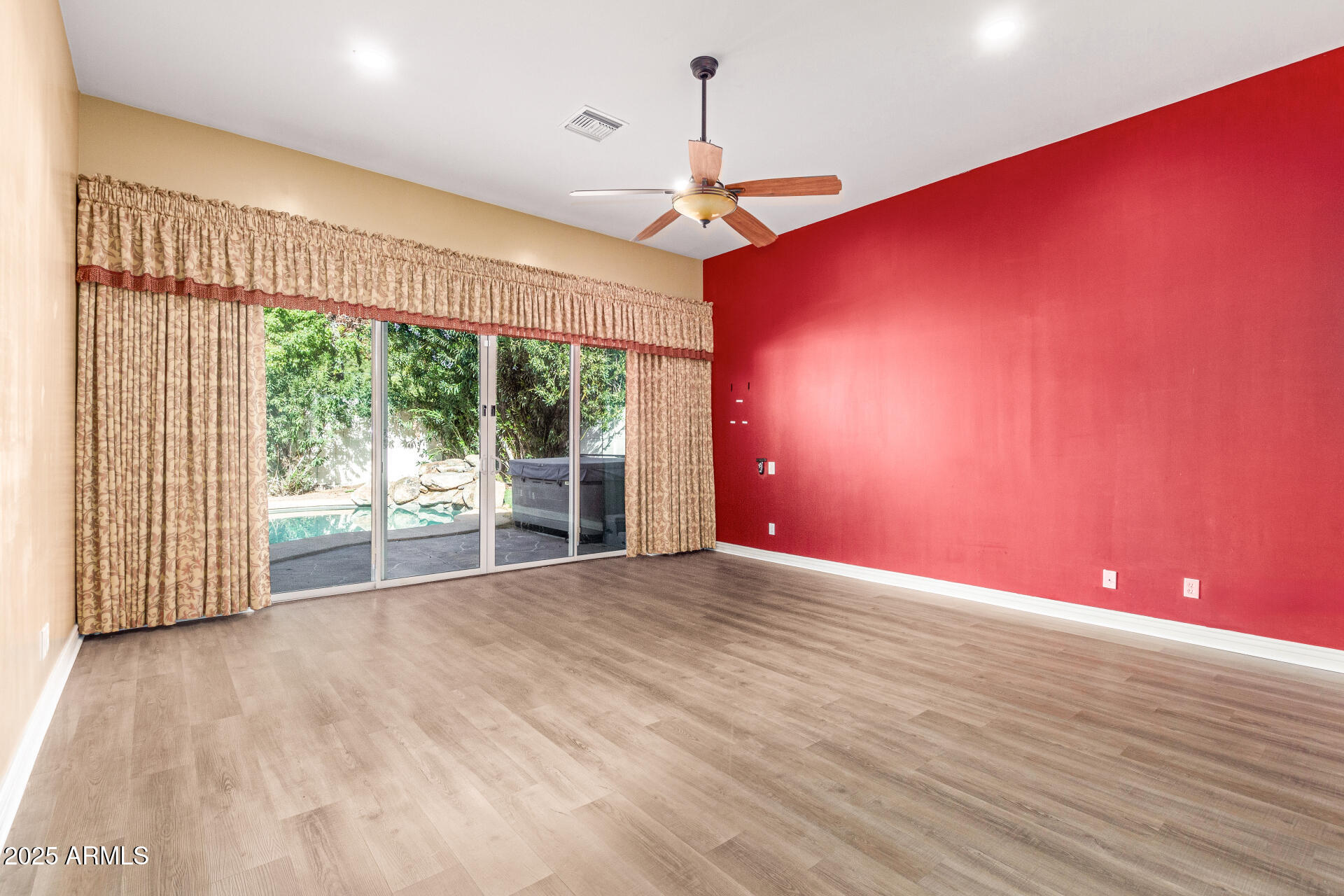 622 West Linger Lane Phoenix, AZ 85021 - Photo 13 of 26 a view of empty room with wooden floor and fan