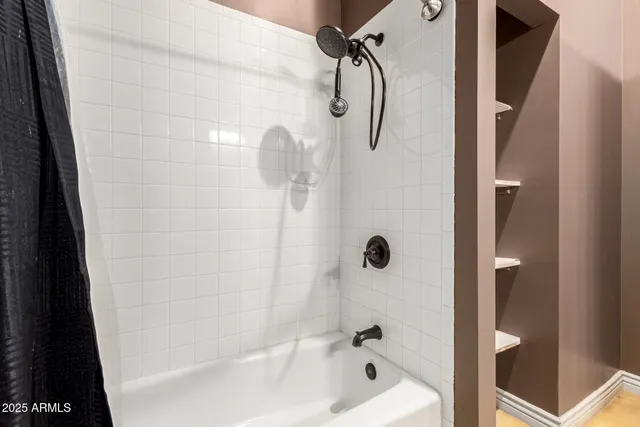 a bathroom with a shower and a bath tub