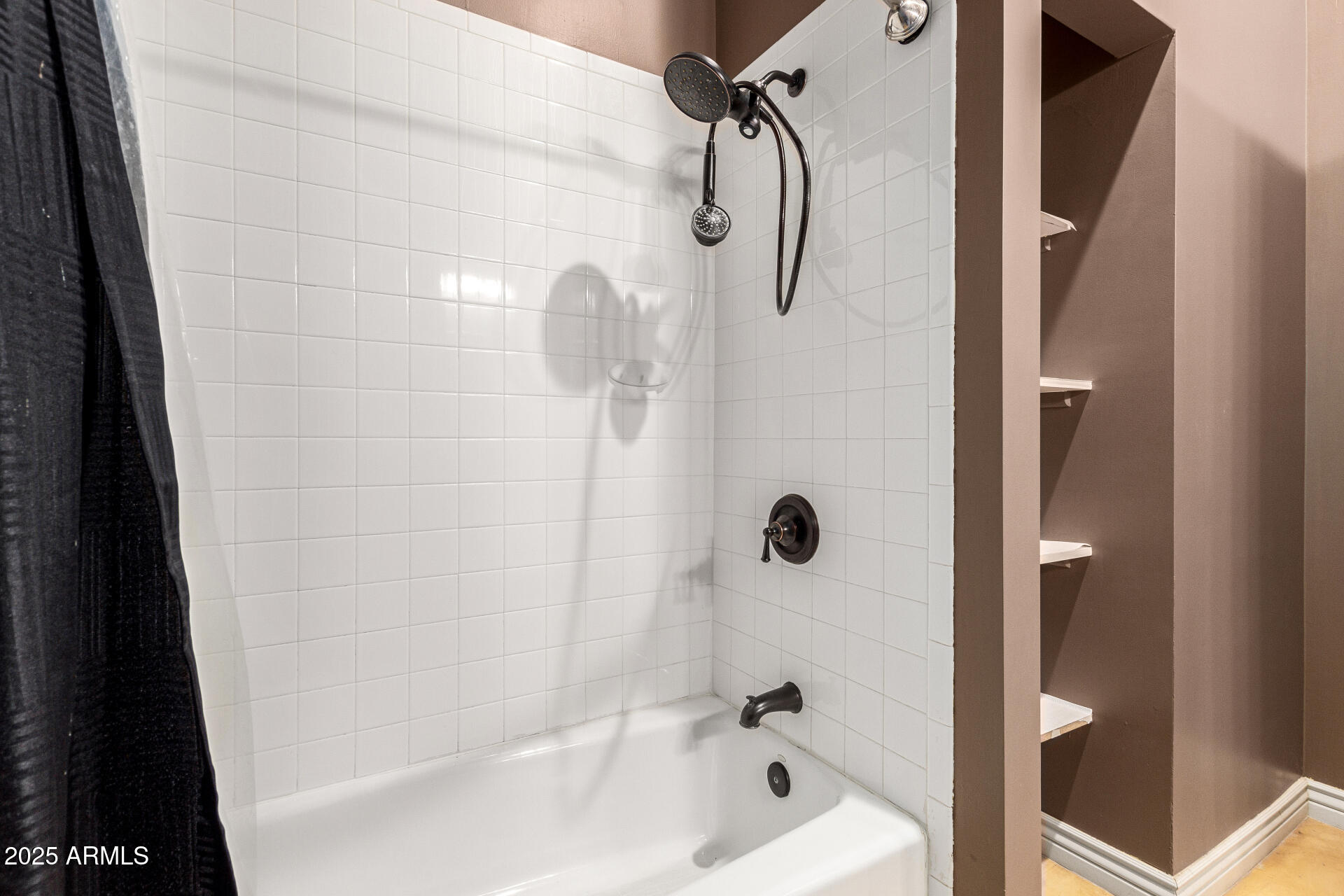 622 West Linger Lane Phoenix, AZ 85021 - Photo 23 of 26 a bathroom with a shower and a bath tub