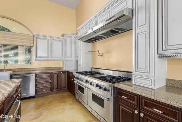 a kitchen with stainless steel appliances granite countertop a stove and a sink