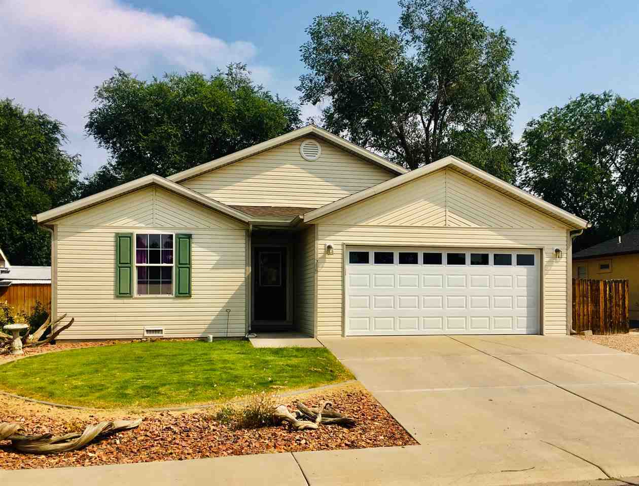 516 Hawthorne Street Fruita, CO 81521 - Photo 1 of 1 a front view of a house with a garden
