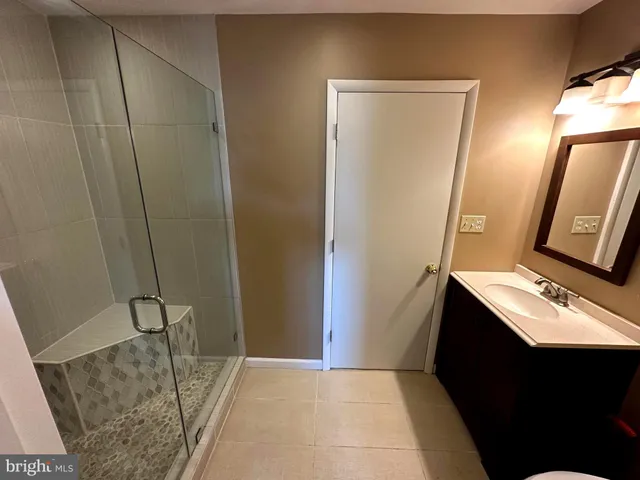 a bathroom with a shower curtain and a sink
