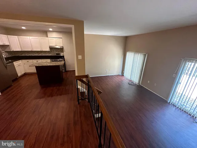 a view of a room with wooden floor