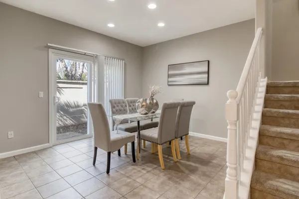 a kitchen with stainless steel appliances kitchen island granite countertop a refrigerator a stove a sink and a oven