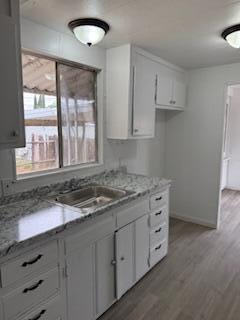 681 South Market Road Earlimart, CA 93219 - Photo 4 of 13 a kitchen with granite countertop a stove a sink and a granite counter tops