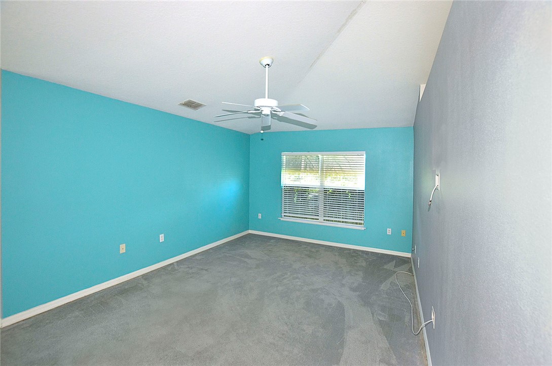 649 Chesser Avenue Sebastian, FL 32958 - Photo 11 of 36 an empty room with a window and a chandelier fan