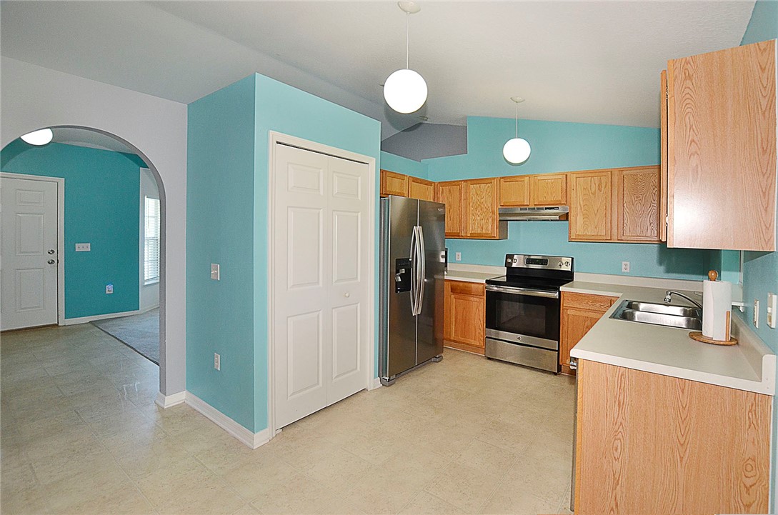 649 Chesser Avenue Sebastian, FL 32958 - Photo 12 of 36 a kitchen with granite countertop a refrigerator and a sink