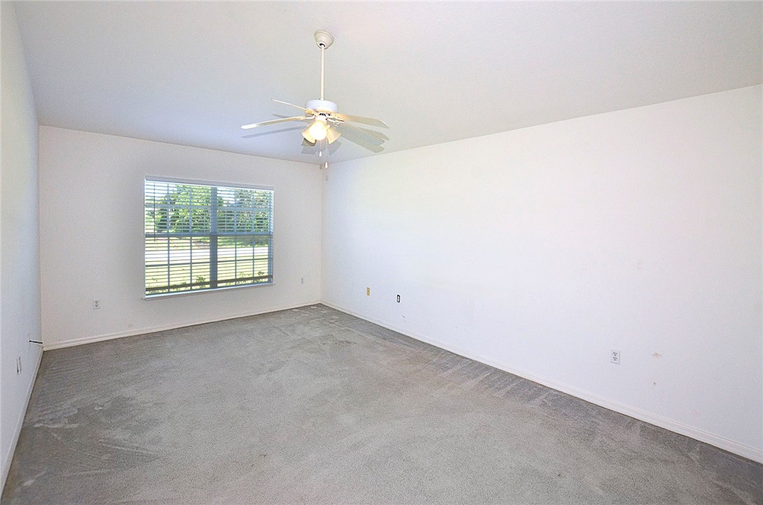 649 Chesser Avenue Sebastian, FL 32958 - Photo 17 of 36 an empty room with windows and fan