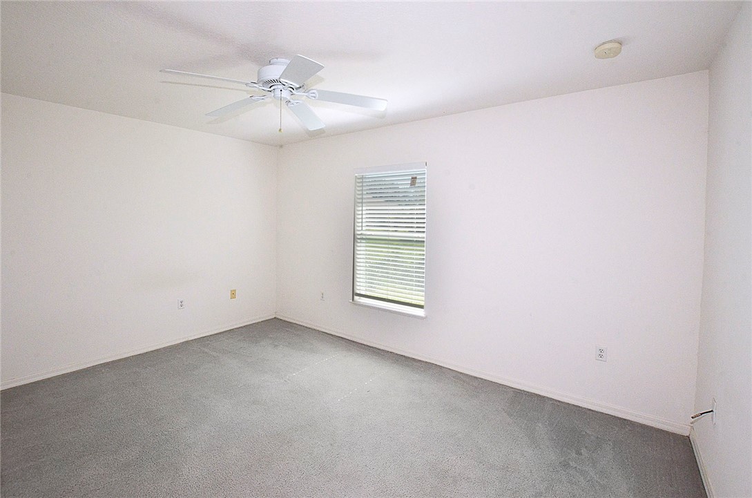 649 Chesser Avenue Sebastian, FL 32958 - Photo 27 of 36 an empty room with a ceiling fan and window