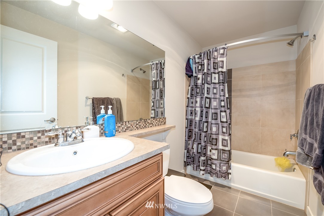 3232 15th Avenue West Seattle, WA 98119 - Photo 14 of 18 a bathroom with a sink a toilet and shower