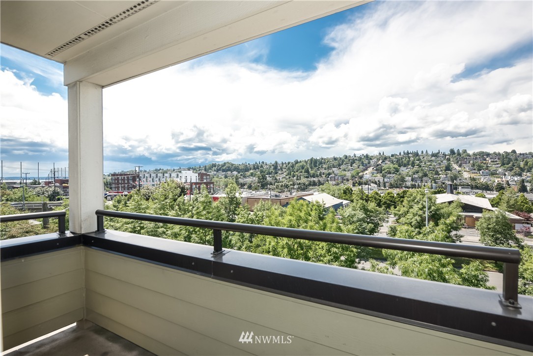 3232 15th Avenue West Seattle, WA 98119 - Photo 15 of 18 a view of a city from a balcony with furniture