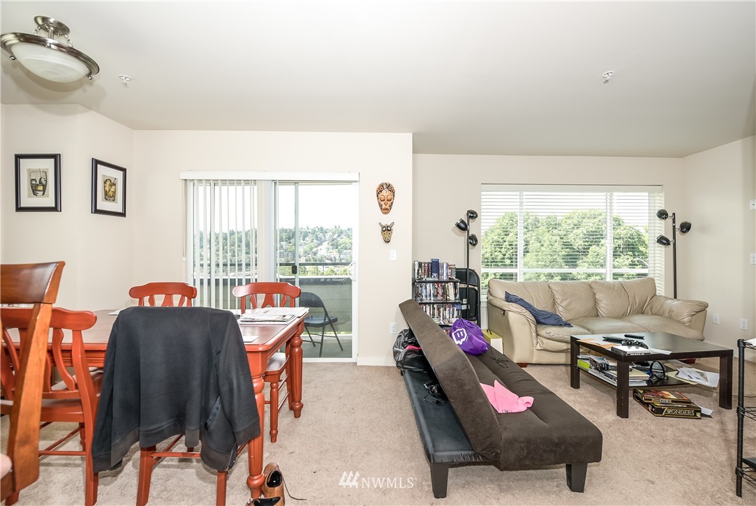 3232 15th Avenue West Seattle, WA 98119 - Photo 17 of 18 a living room with furniture and a floor to ceiling window