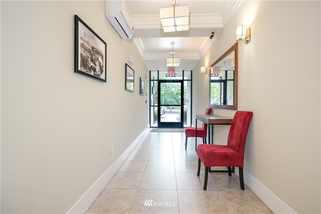 3232 15th Avenue West Seattle, WA 98119 - Photo 5 of 18 a view of a hallway with furniture and a potted plant