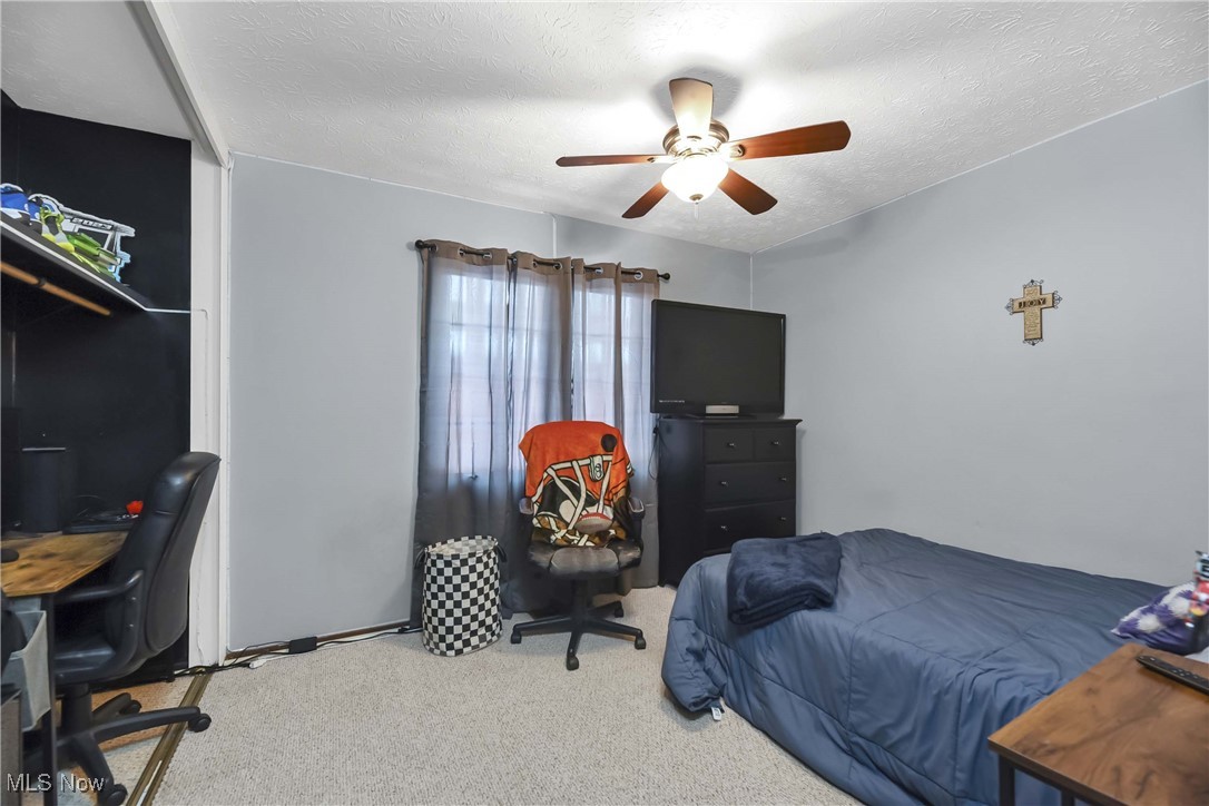 10778 Gate Post Road Strongsville, OH 44149 - Photo 27 of 40 Carpeted bedroom with ceiling fan and a textured ceiling
