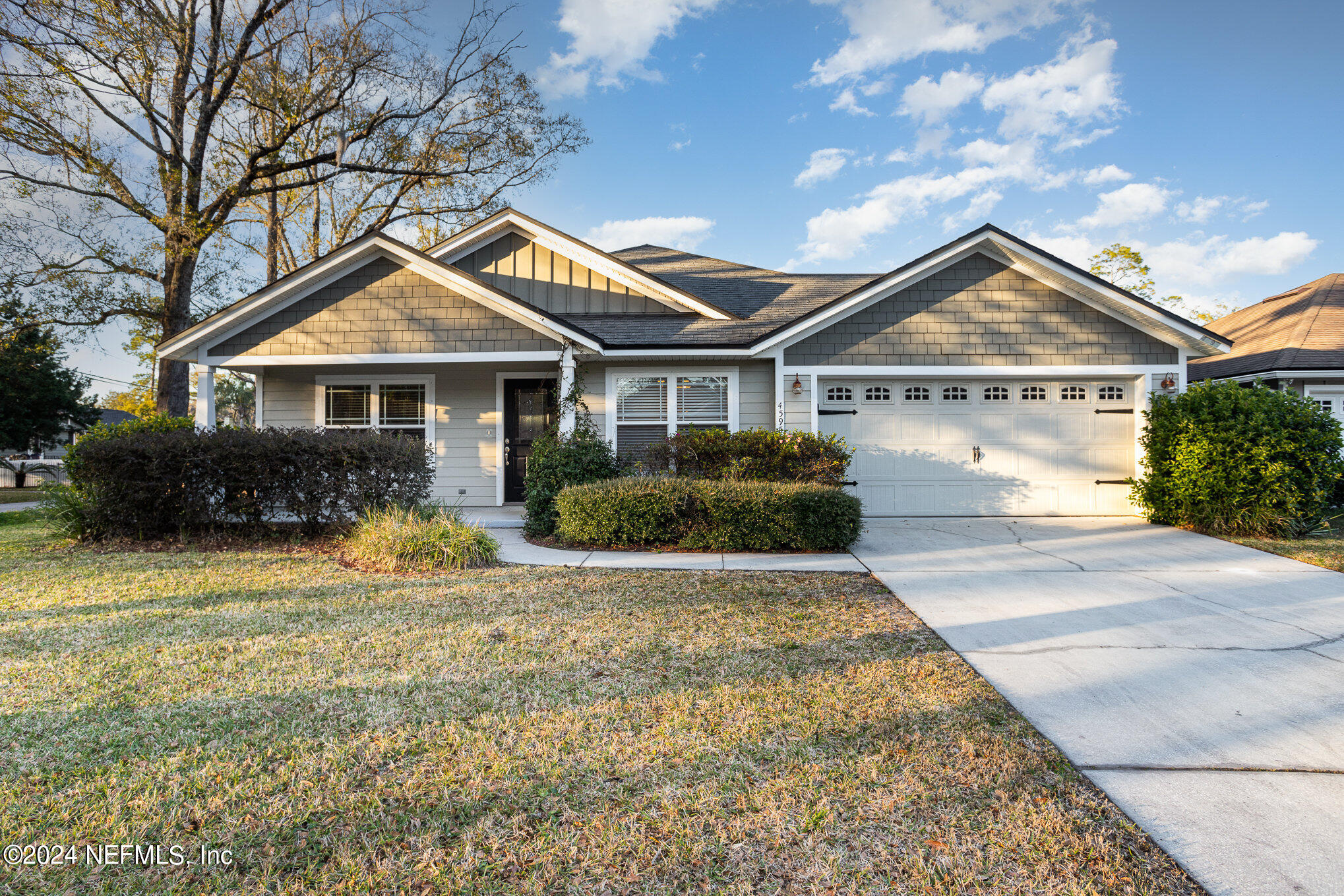 4595 Prunty Avenue Jacksonville, FL 32205 - Photo 1 of 15 a front view of a house with a yard and potted plants